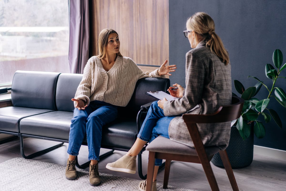 Woman Sitting on the Couch Talking to the Psychologist.